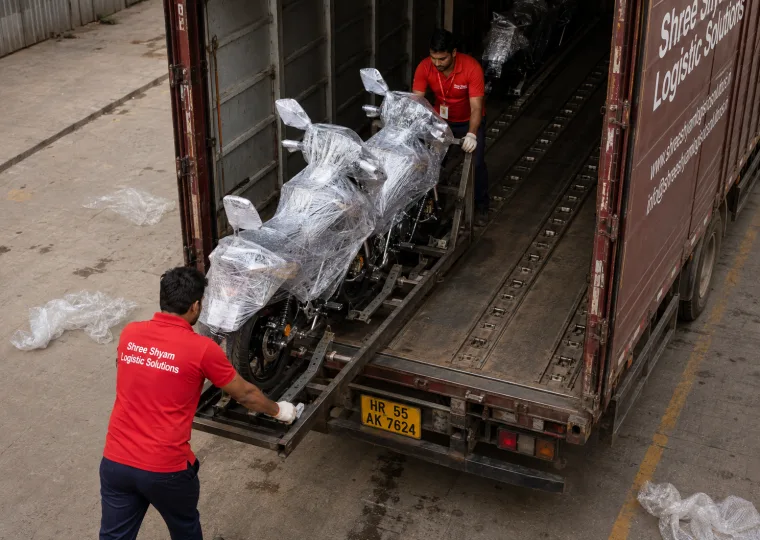 Wrapped motorcycle standing upright on a transport rack inside a closed bike carrier